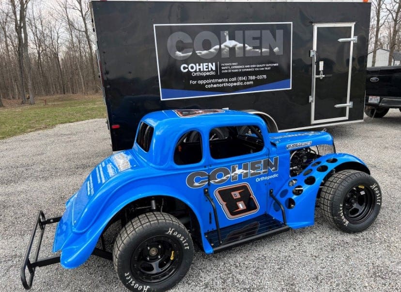 Cohen Orthopedic race car with number 8 parked beside a trailer.